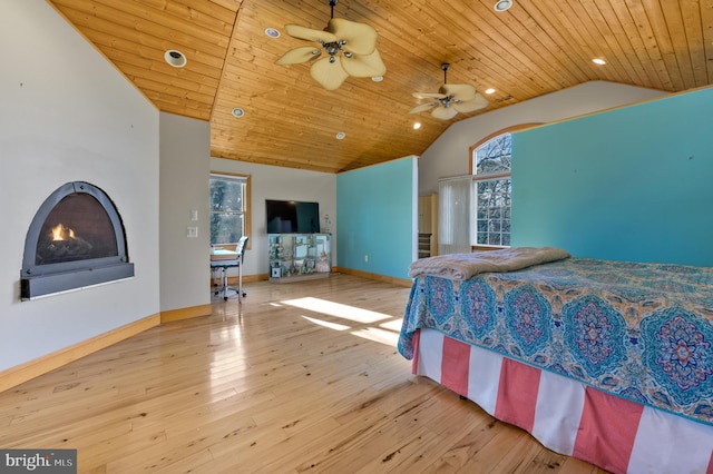 bedroom with ceiling fan, light hardwood / wood-style floors, wood ceiling, and high vaulted ceiling