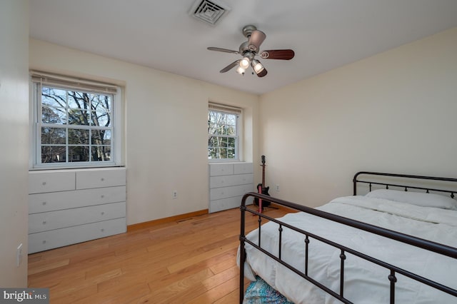 bedroom with light hardwood / wood-style flooring and ceiling fan