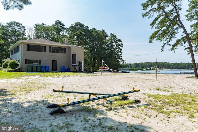 view of community featuring a water view and volleyball court