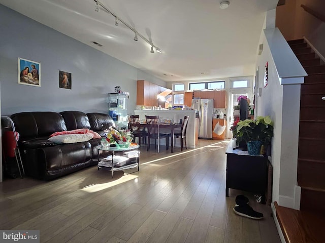 922 Wallace St, Philadelphia, PA 19123 - living area featuring track lighting, stairs, and light wood-type flooring