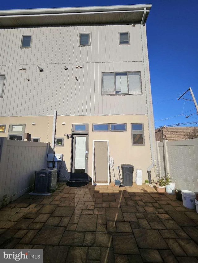 back of house with a patio area and central air condition unit