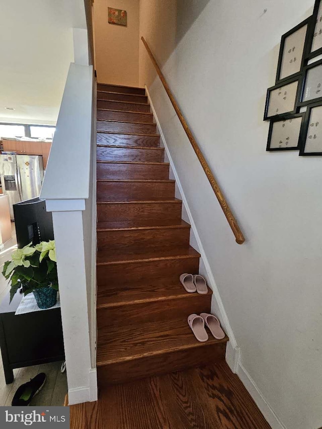 stairs featuring hardwood / wood-style flooring