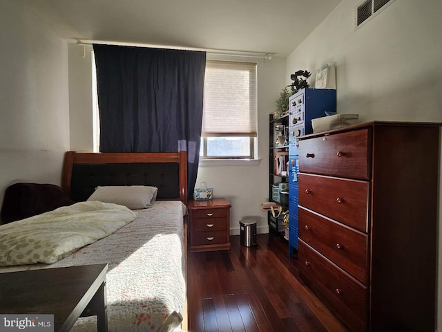 bedroom with dark hardwood / wood-style flooring