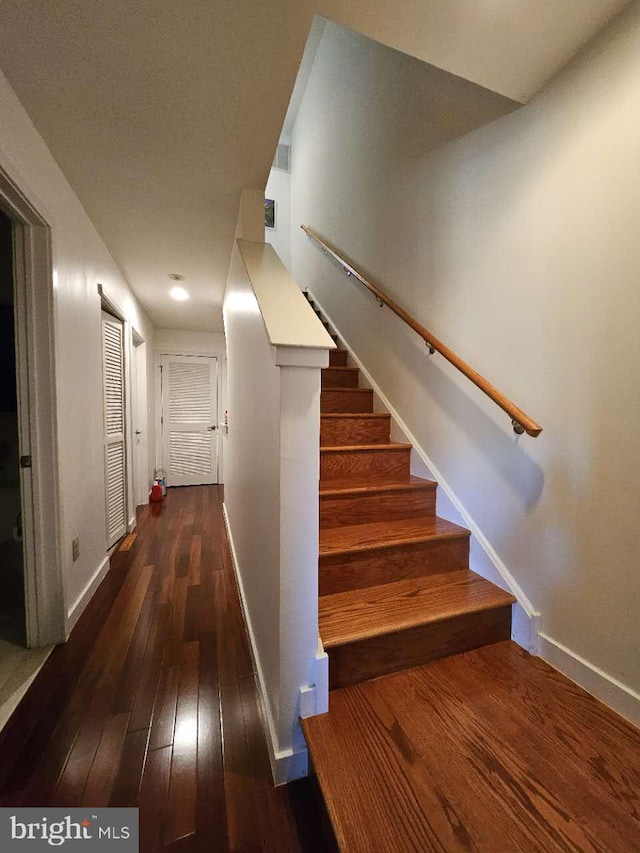 stairway featuring wood-type flooring