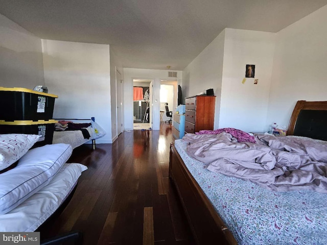 bedroom with dark wood-type flooring