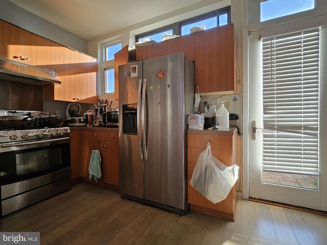 922 Wallace St, Philadelphia, PA 19123 - kitchen with stainless steel appliances, under cabinet range hood, light wood-type flooring, and brown cabinetry
