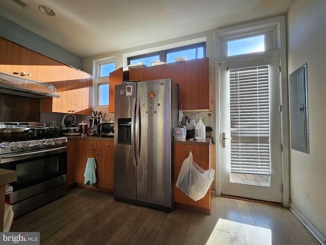 kitchen with backsplash, electric panel, dark hardwood / wood-style floors, range hood, and appliances with stainless steel finishes