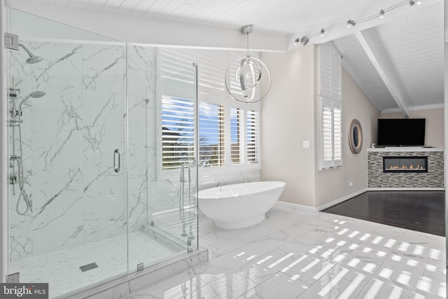 bathroom featuring separate shower and tub, lofted ceiling with beams, and a tile fireplace