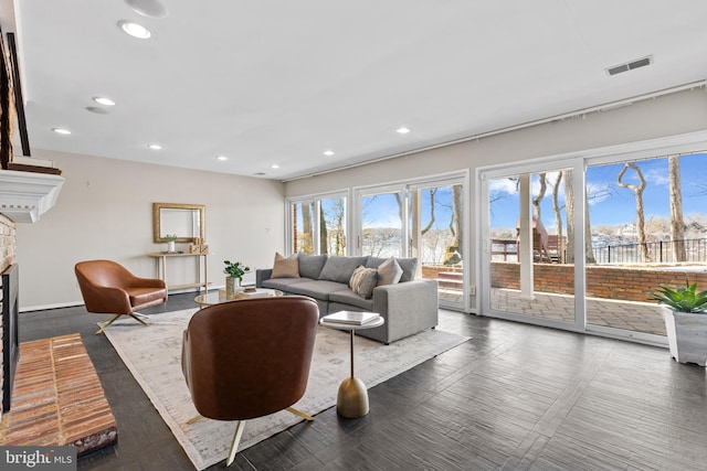 living room featuring a brick fireplace