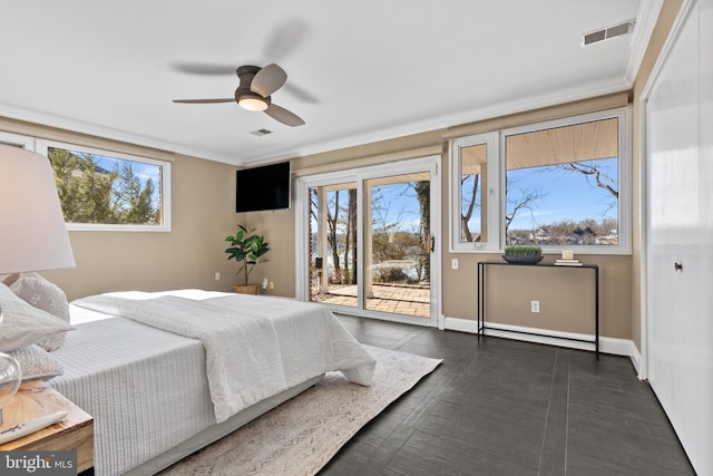 bedroom featuring multiple windows, ornamental molding, and access to outside