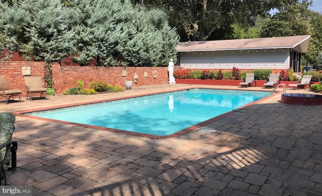 view of pool featuring a patio and an outdoor fire pit