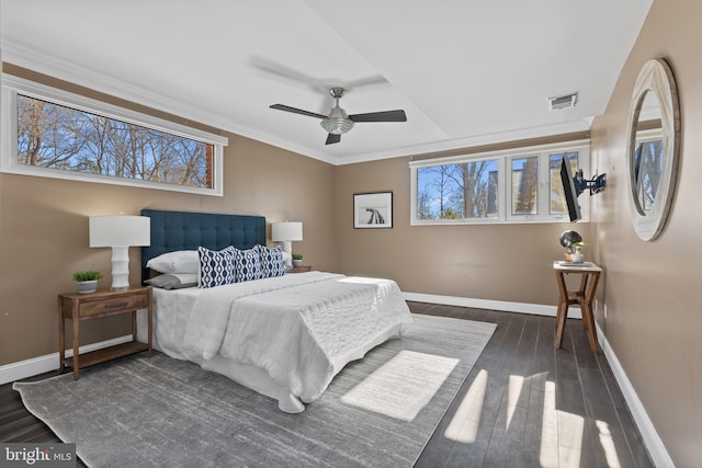 bedroom with crown molding, dark hardwood / wood-style floors, and ceiling fan