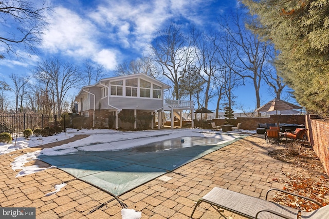 view of pool featuring a patio and a sunroom