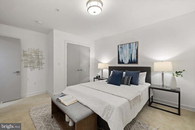 bedroom featuring a closet and light colored carpet