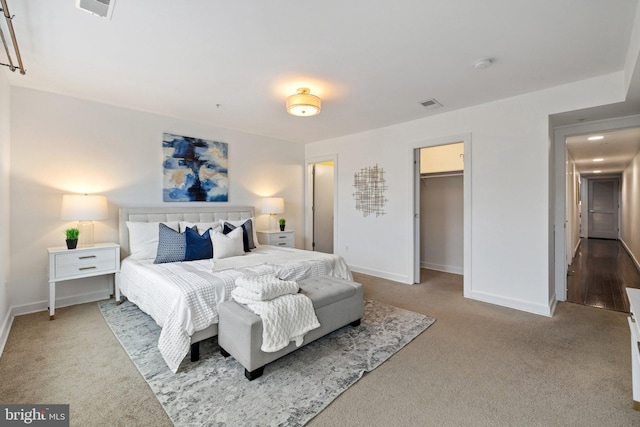 bedroom featuring carpet flooring, a spacious closet, and a closet