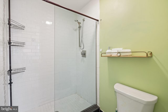 bathroom featuring an enclosed shower and toilet