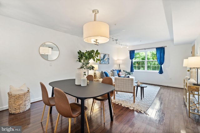 dining space with dark hardwood / wood-style flooring