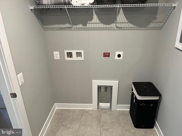 laundry room featuring tile patterned flooring, washer hookup, and hookup for an electric dryer