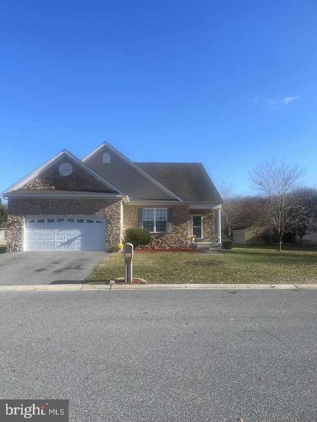 view of front of home featuring a front yard and a garage