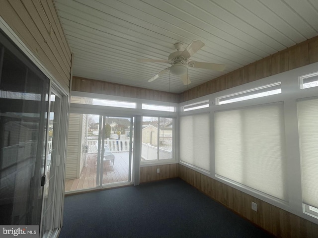 unfurnished sunroom with ceiling fan