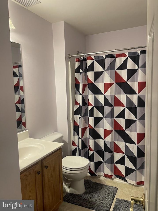 bathroom with tile patterned floors, vanity, and toilet