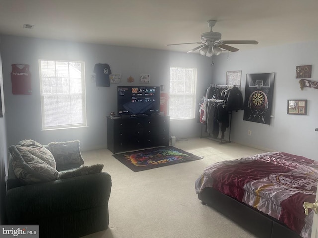 bedroom with ceiling fan and light carpet