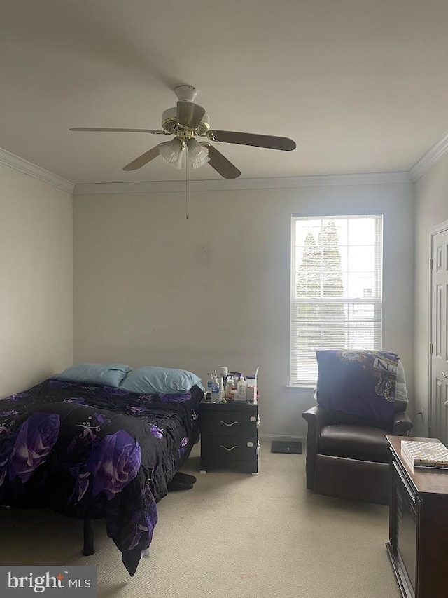 carpeted bedroom featuring ceiling fan and ornamental molding