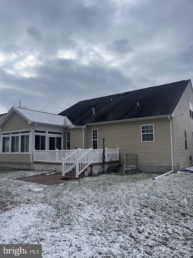 back of property with a wooden deck