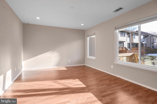 unfurnished room featuring hardwood / wood-style floors