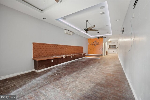 2808 Germantown Ave, Philadelphia, PA 19133 - interior space featuring a raised ceiling, a wall unit AC, ceiling fan, and wood finished floors