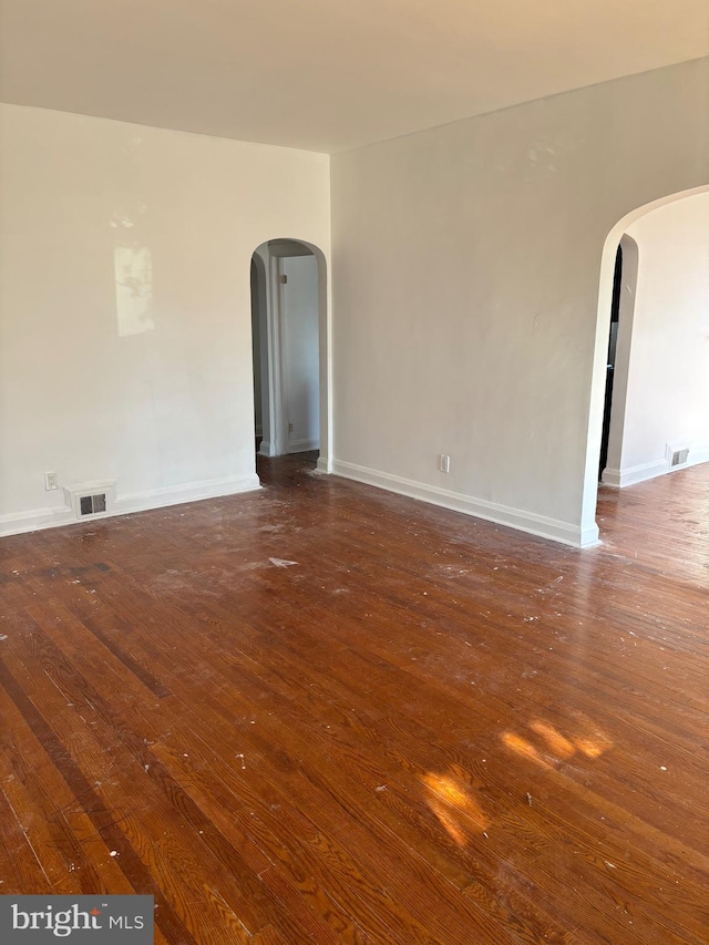 unfurnished room with dark hardwood / wood-style floors