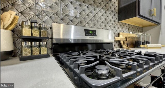 interior details with gas stove and backsplash