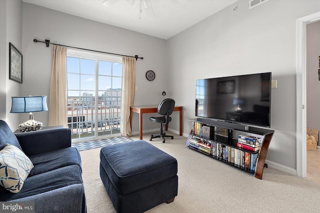 carpeted living room featuring ceiling fan