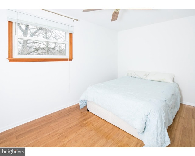 bedroom featuring hardwood / wood-style flooring and ceiling fan