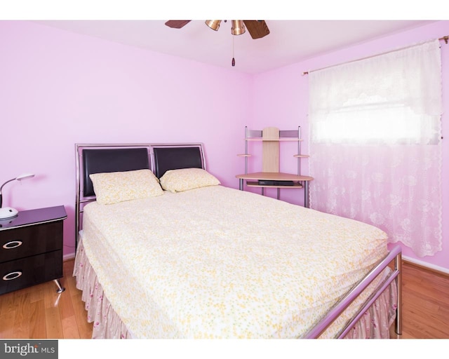 bedroom with light hardwood / wood-style floors and ceiling fan