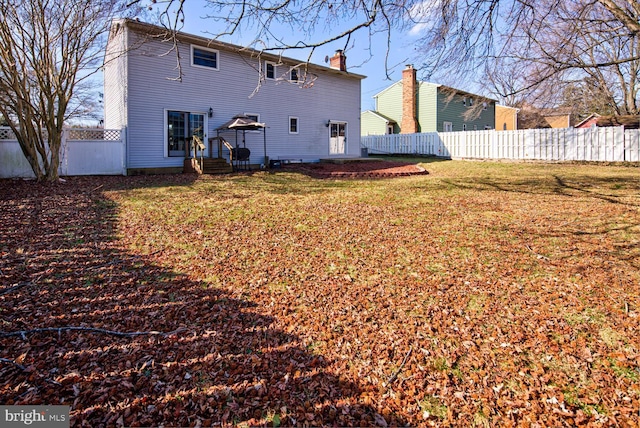 back of house with a yard