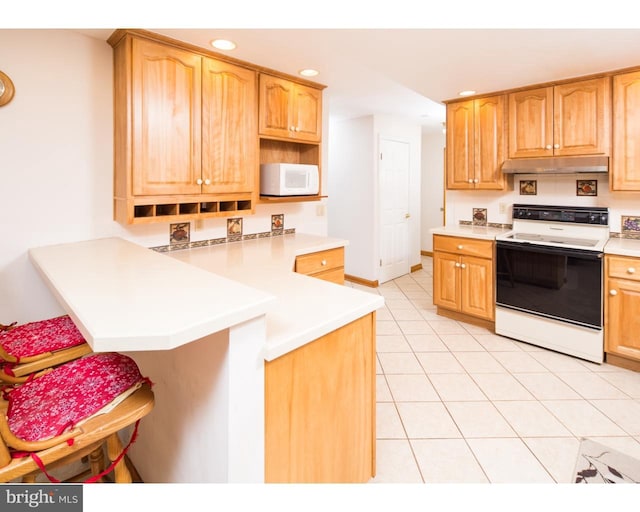 kitchen with electric range, kitchen peninsula, and light tile patterned flooring