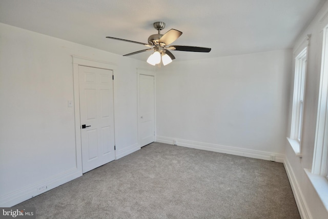 unfurnished bedroom featuring ceiling fan and light colored carpet