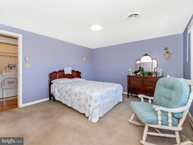 bedroom with washer / dryer, carpet floors, and a spacious closet