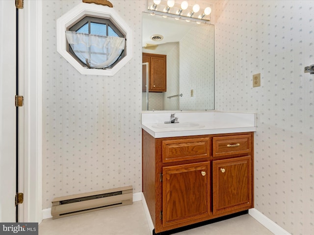 bathroom with vanity and a baseboard heating unit