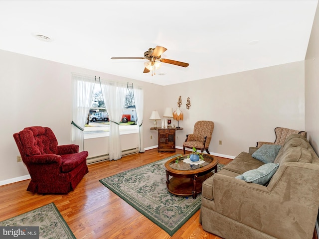 living room featuring hardwood / wood-style flooring, a baseboard radiator, and ceiling fan