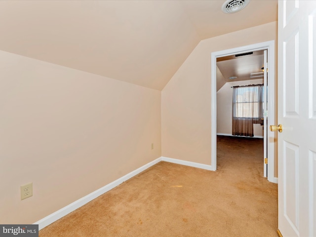 bonus room featuring light carpet and vaulted ceiling