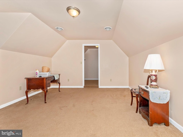 interior space featuring light carpet and vaulted ceiling