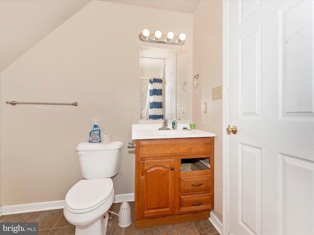 bathroom with curtained shower, vanity, and toilet