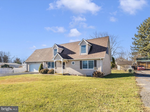 cape cod home featuring a garage and a front lawn