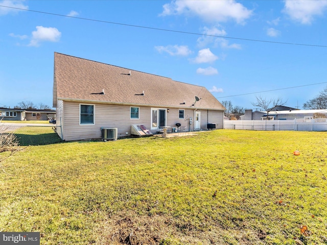 back of property featuring central AC, a patio area, and a yard