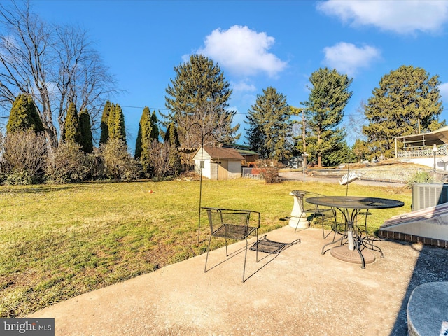 view of patio / terrace featuring cooling unit and a storage shed