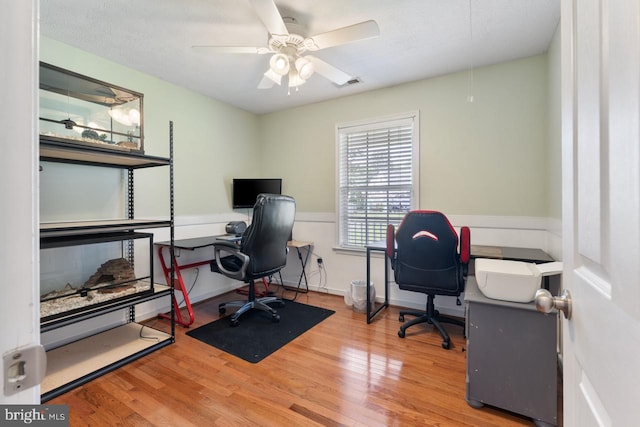 office area with ceiling fan and light hardwood / wood-style floors