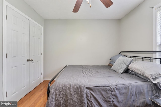 bedroom featuring a closet, light hardwood / wood-style floors, and ceiling fan