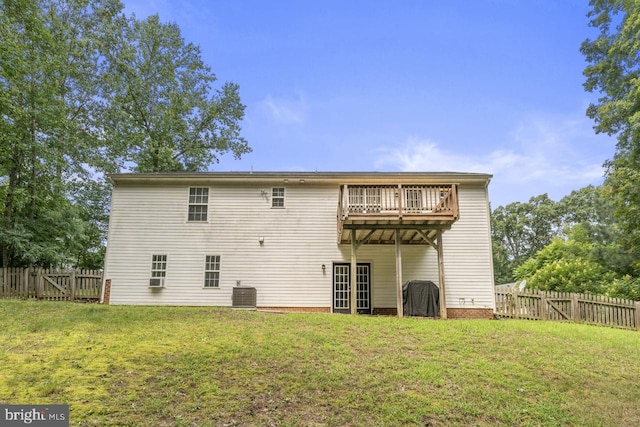 back of property with cooling unit, a deck, and a yard